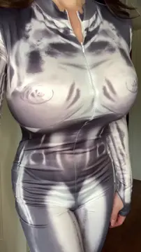 Bimbo revealing her massive fake boobs out of a tight bodysuit